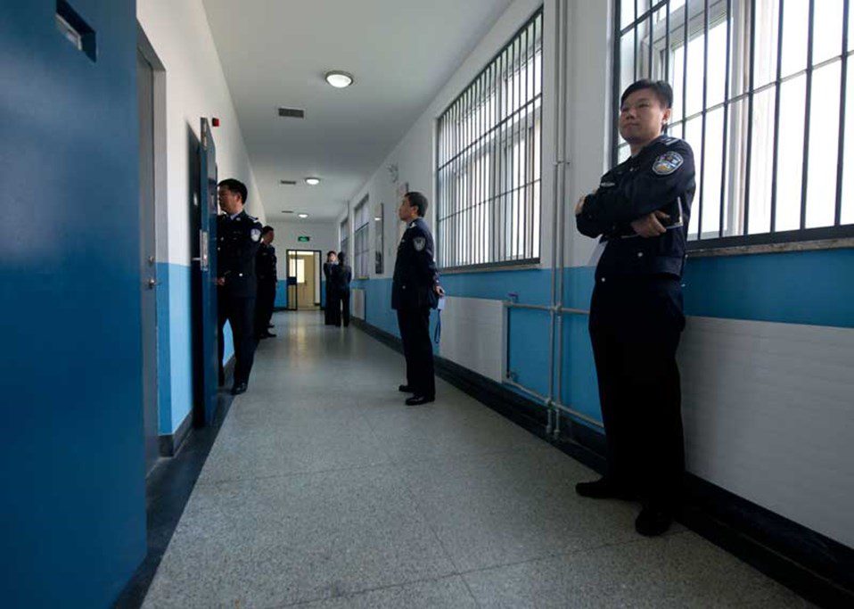 Police guards stand in a hallway inside the No.1 Detention Center, Beijing on 25 October, 2012. © Ed Jones/AFP/Getty Images