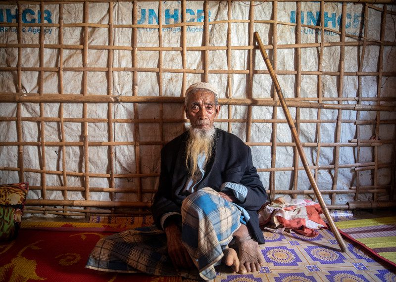 older man sitting in the camp