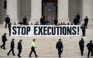 Police officers gather to remove activists during an anti death penalty protest in front of the US Supreme Court January 17, 2017 in Washington, DC.