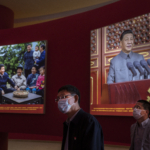 Party members stand by image showing Chinese President Xi Jinping